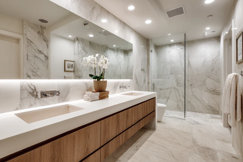 Spa bathroom with white quartz and wood accents