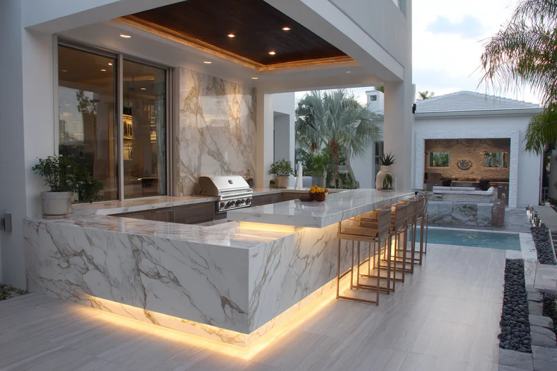 Outdoor kitchen with LED underglow lighting and pool